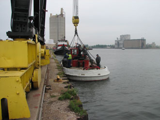 Port Ops staff lift the Harbor Segull out for painting and minor repairs