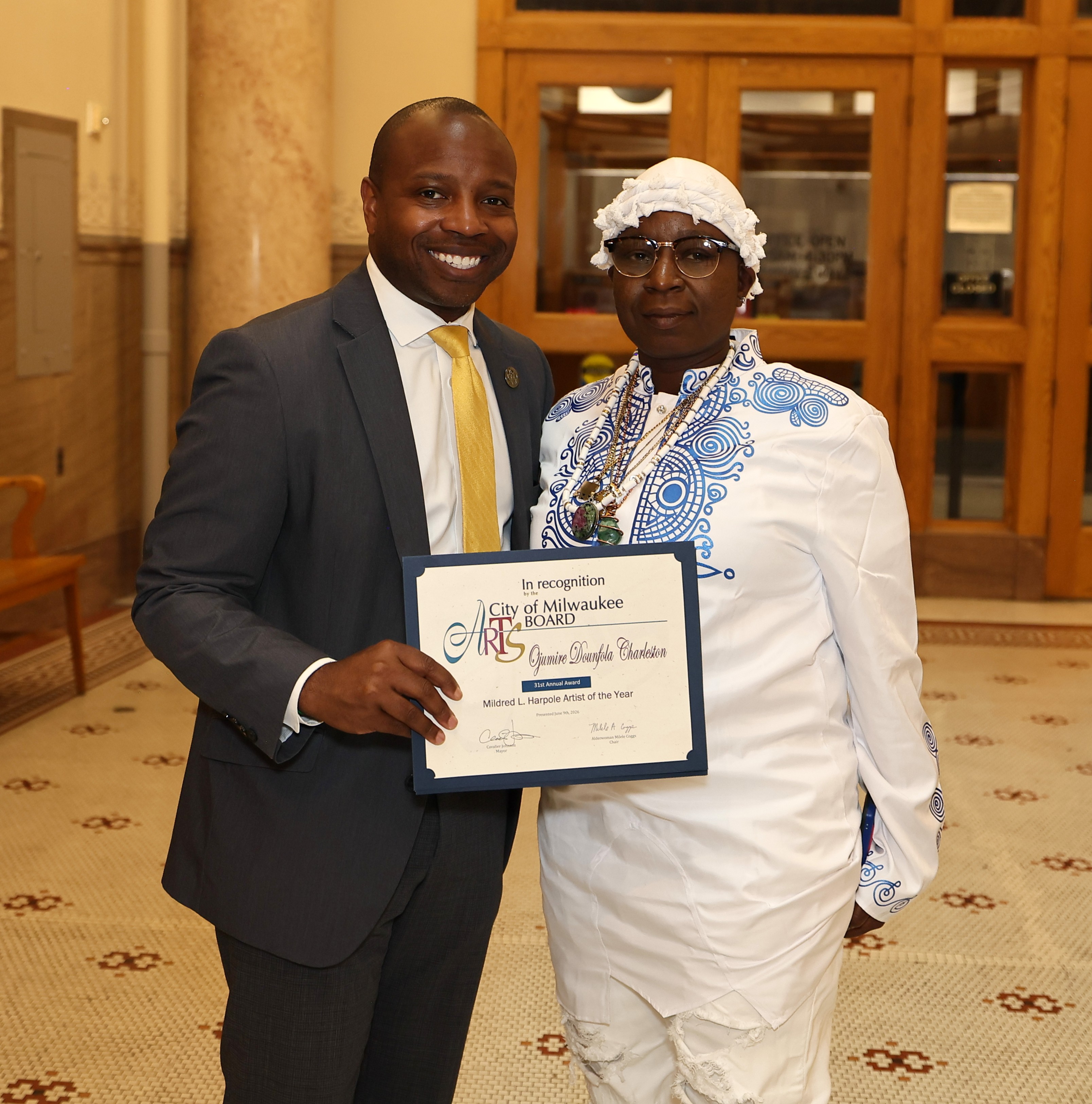 Mayor holds certificate with honoree