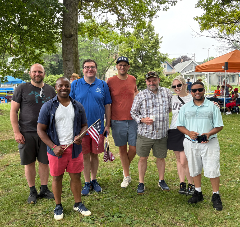 Mayor holding American flag with City staff