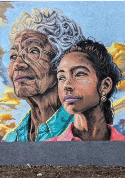 A vibrant mural depicting a portrait of Martin Luther King Jr., set against colorful backgrounds with white doves and "MLK MKE" text. The scene conveys hope and unity.