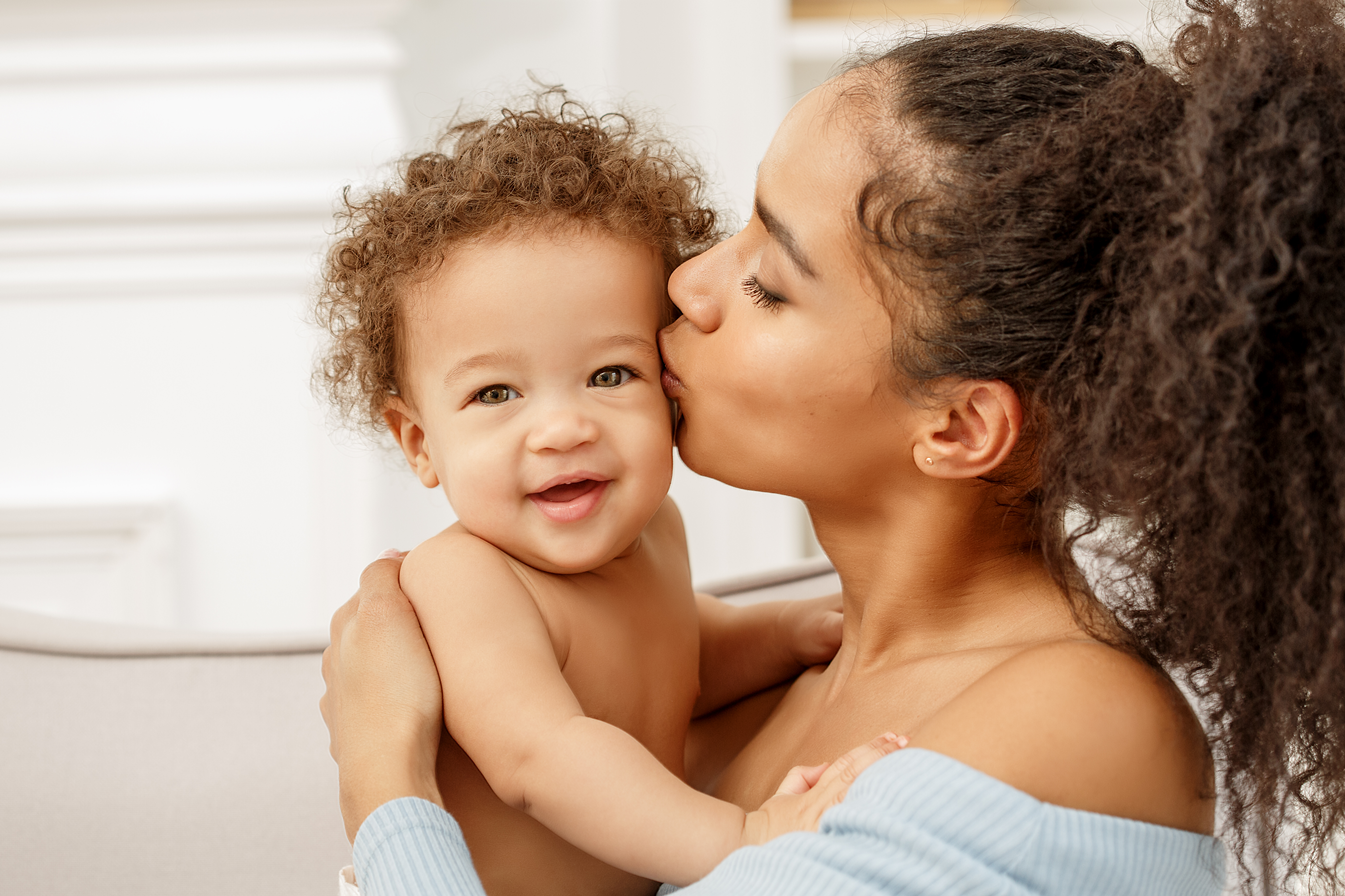 Mother kissing young child