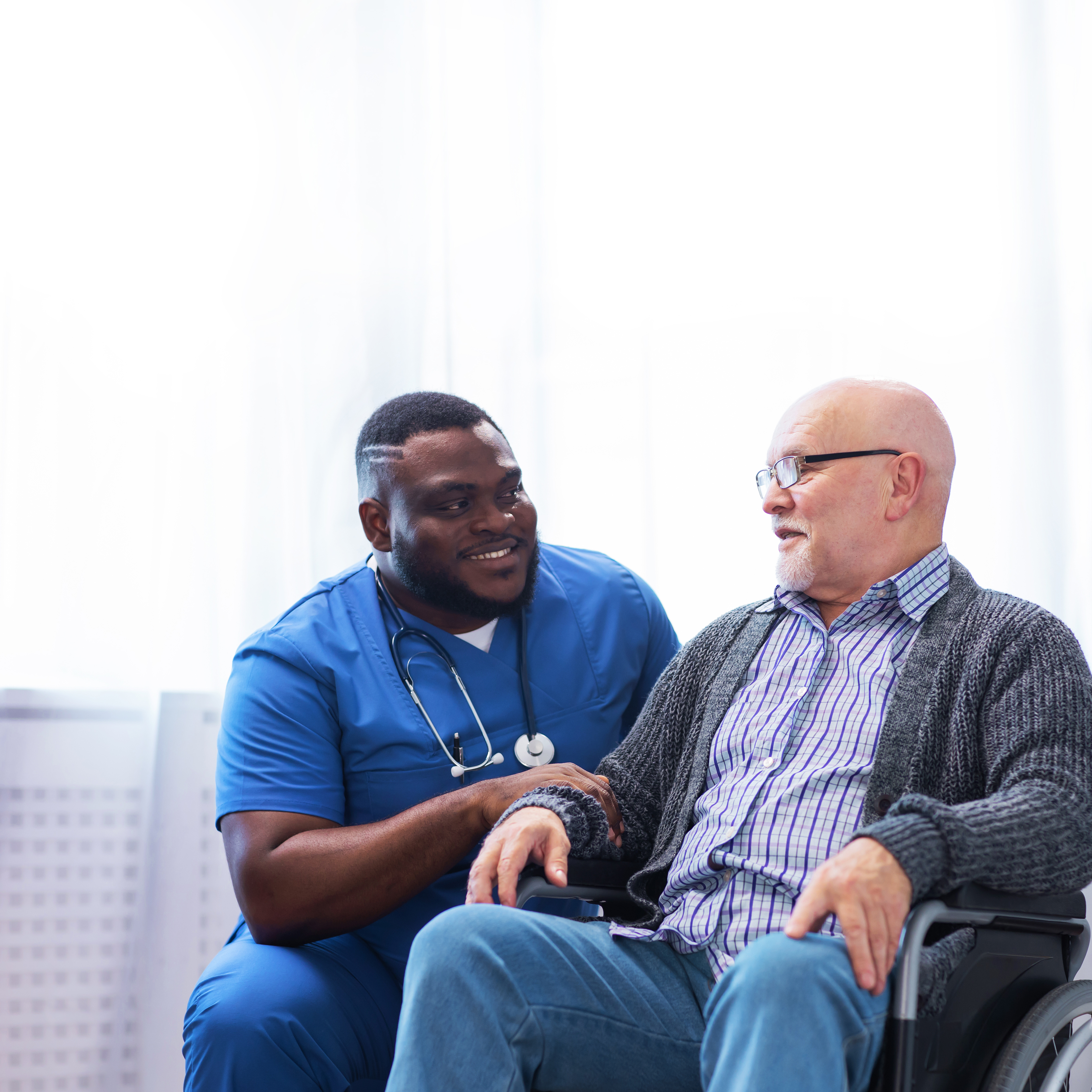 Healthcare provider assisting an elderly patient