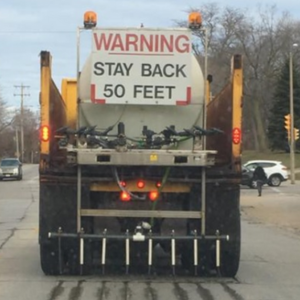 Image of a City of Milwaukee brine truck applying a saltwater solution plowing to a main street.