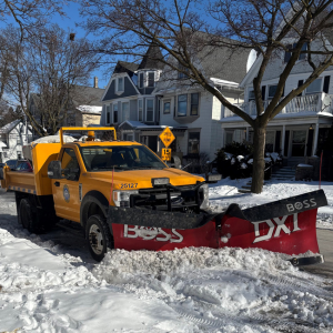Image of a City of Milwaukee light duty truck plowing a residential street.