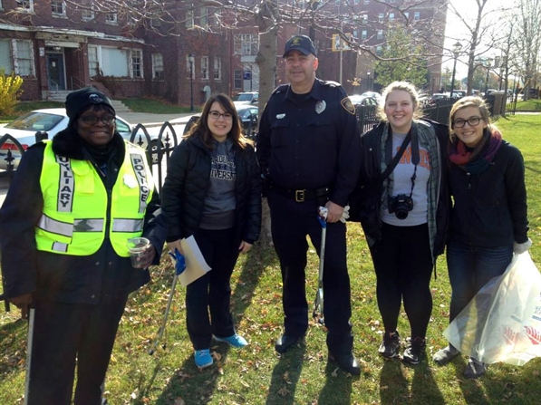 Photo of MPD officer and neighbors during a neighborhood cleanup event